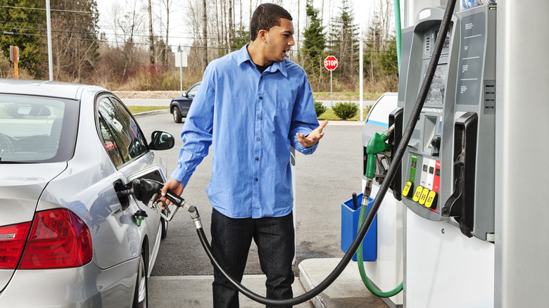 Man filling car with gasoline