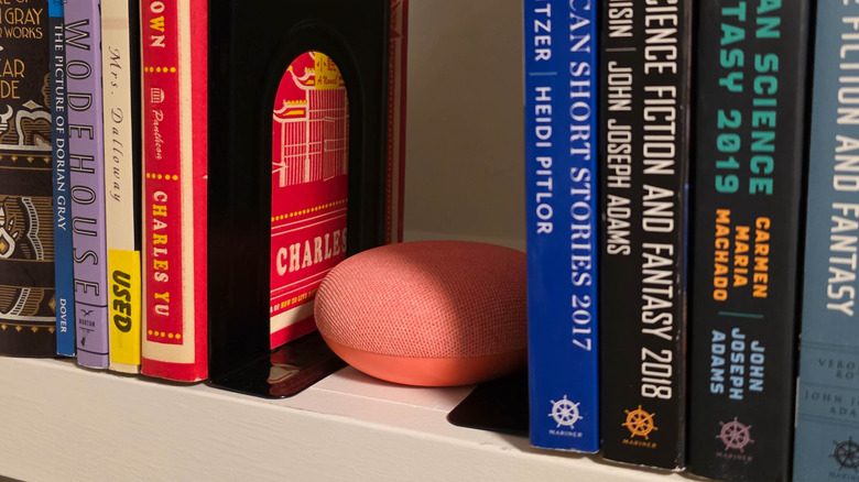 Google Nest Mini speaker on bookshelf