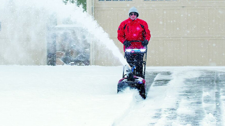 person using toro power clear blower