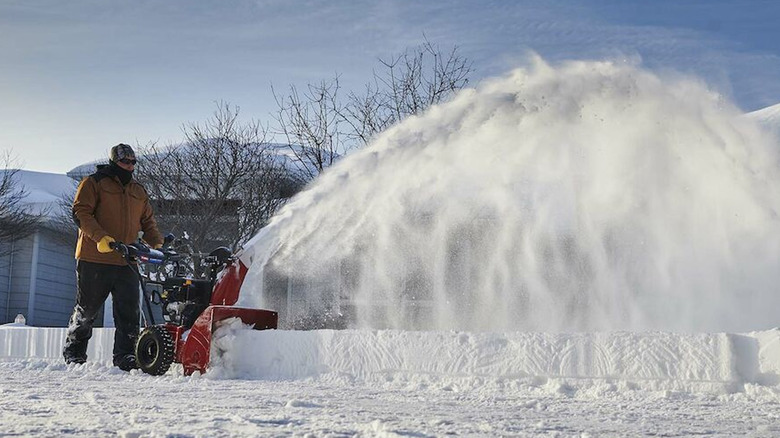 person using toro power max snow blower