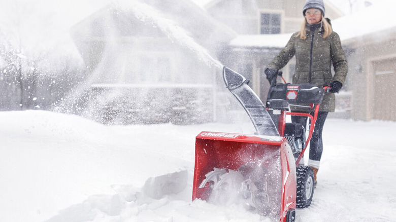 person using troy-bilt snow blower