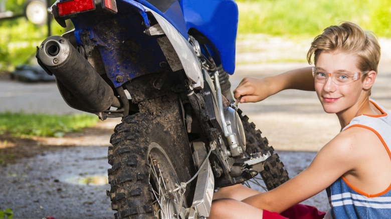 Kid working on dirt bike