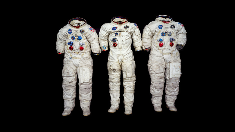 Apollo 11 spacesuits on a black background