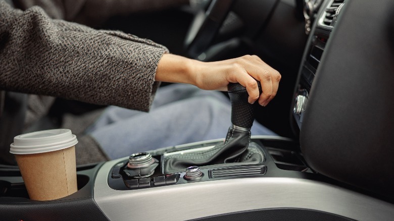 Driver with hand on shifter