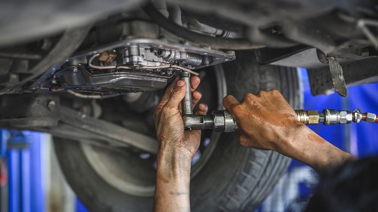 mechanic working on a transmission