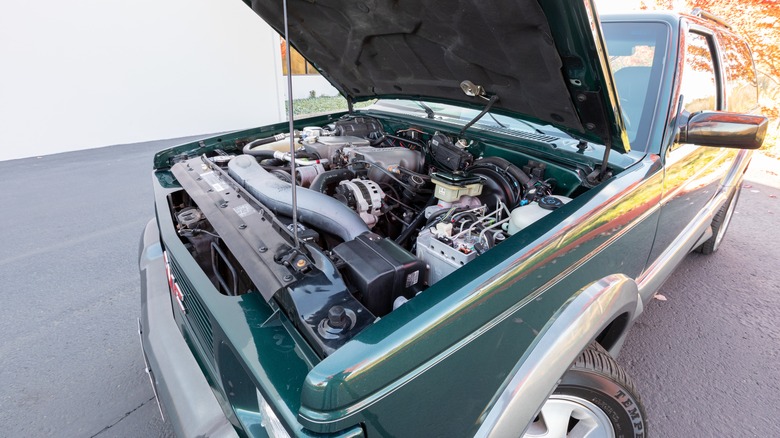 The hood is lifted on a 1993 GMC Typhoon, revealing the engine.