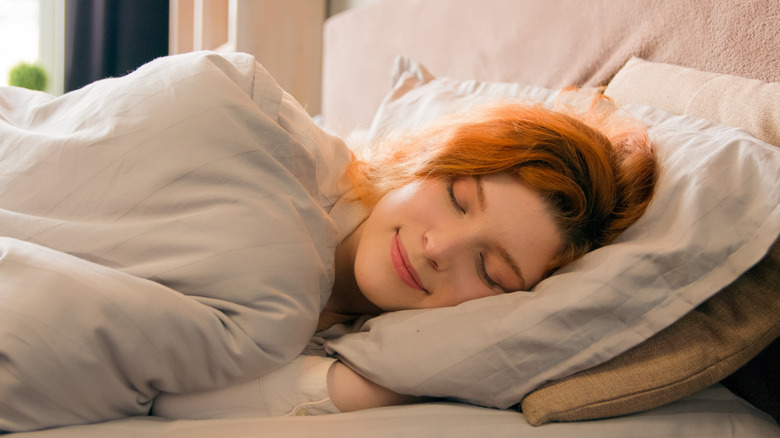 A woman sleeping comfortably on the bed