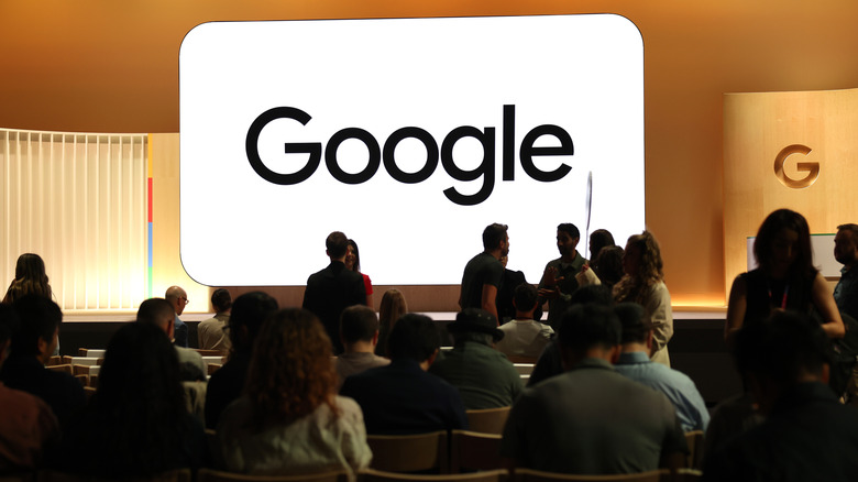 Auditorium with a large illuminated display of Google's name