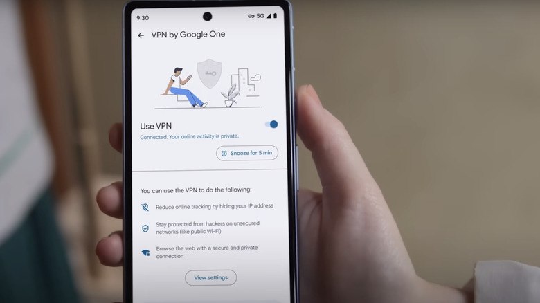 A hand holding a Pixel phone displaying the settings page of VPN by Google One