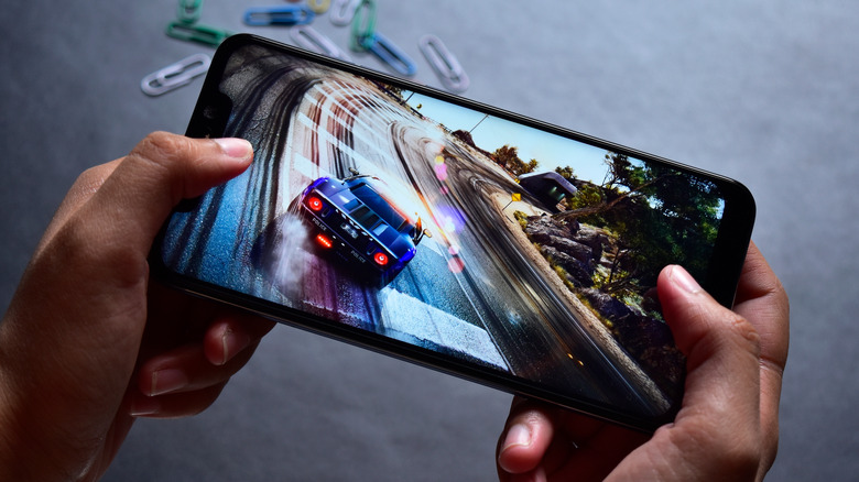 Playing a racing game on an Android phone. 
