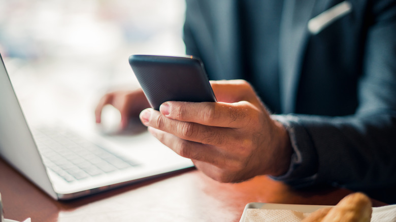 person checking phone while working