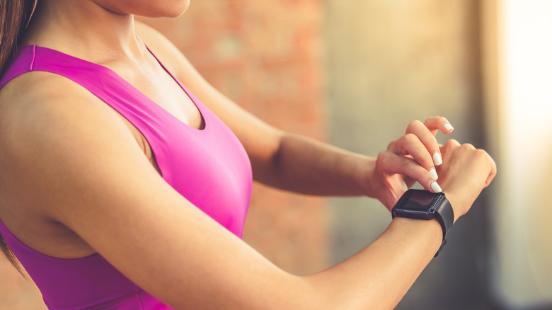 Woman using a Fitbit watch.