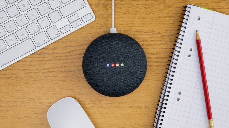 Google Nest Mini with keyboard and notebook