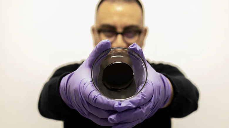 Scientist holding sample of a self-healing bitumen