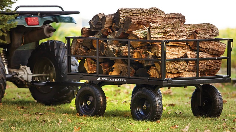 Gorilla Made utility cart loaded with firewood hitched to an ATV