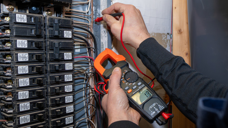 electrician testing electrical panel