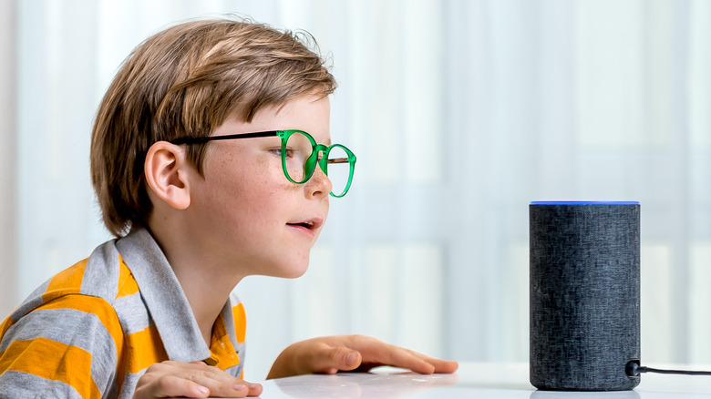 Child next to Alexa speaker