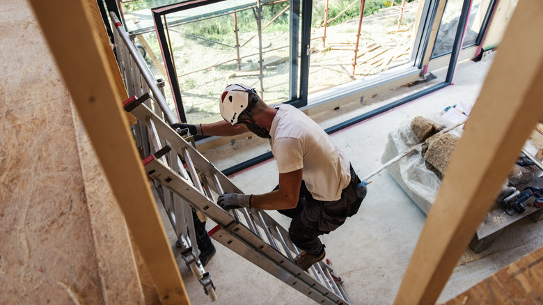 Man climbing down from ladder