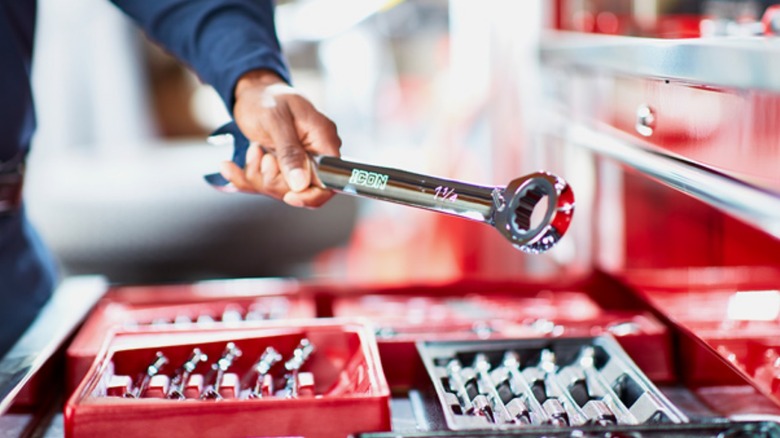 Mechanic taking Icon wrench from set