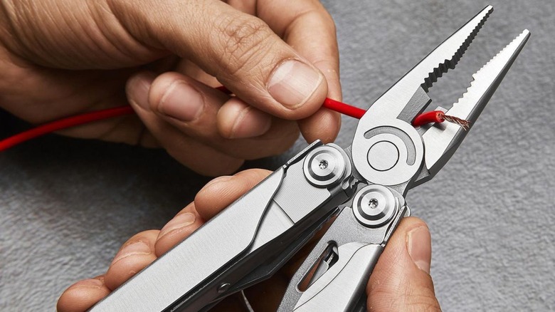 Person using multi-tool to cut wires