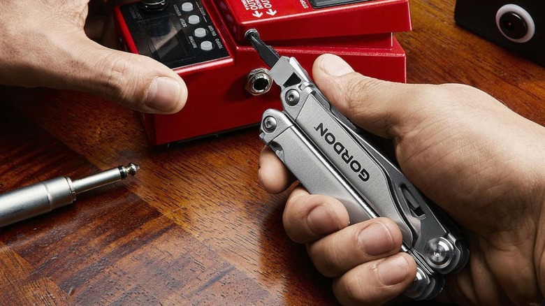 Person using multi-tool screwdriver