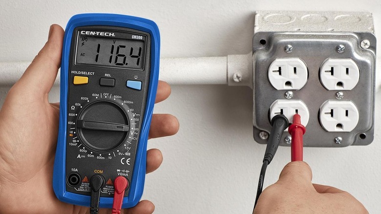 CEN-TECH 9-Function Digital Multimeter plugged into an outle