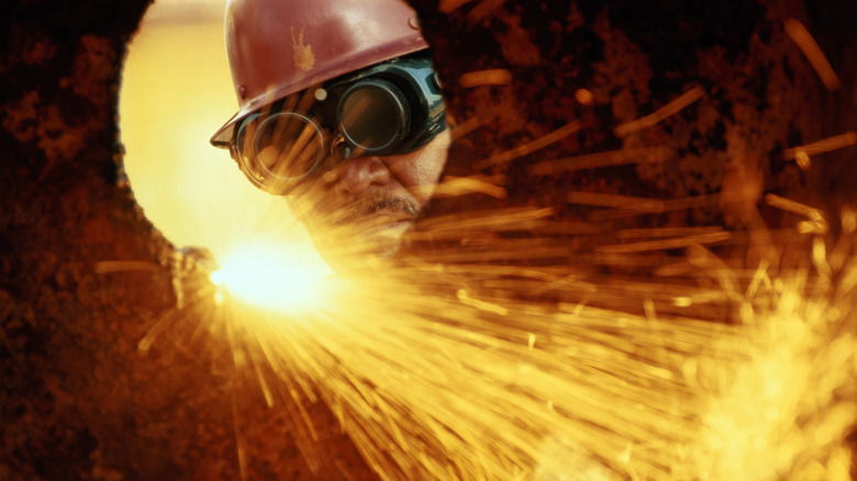 Welder with brown hard hat