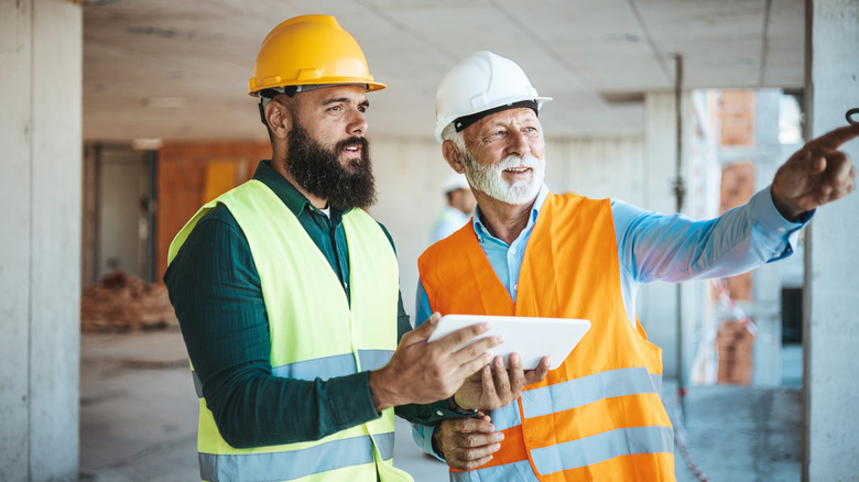 Construction manager talks to worker