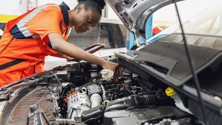 person working on a car engine