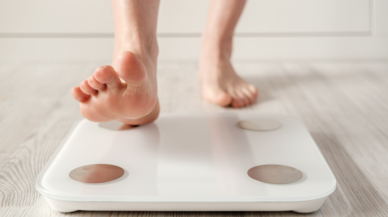 Person stepping onto smart scale