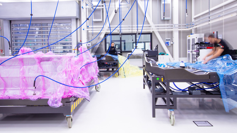 Lamborghini workers prep large structural components in bags ahead of a visit to the autoclave.