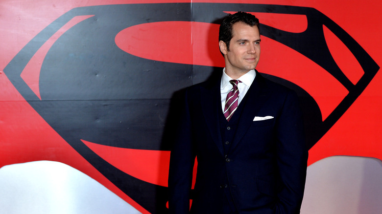 Henry Cavill in front of Superman logo