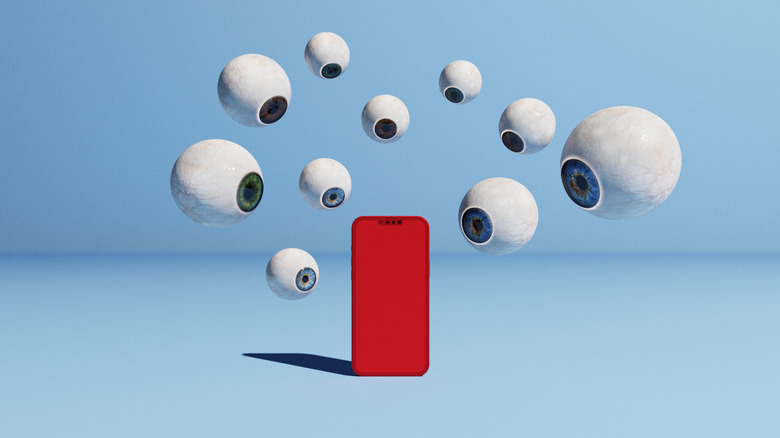 eyeballs on phone symbolizing spying
