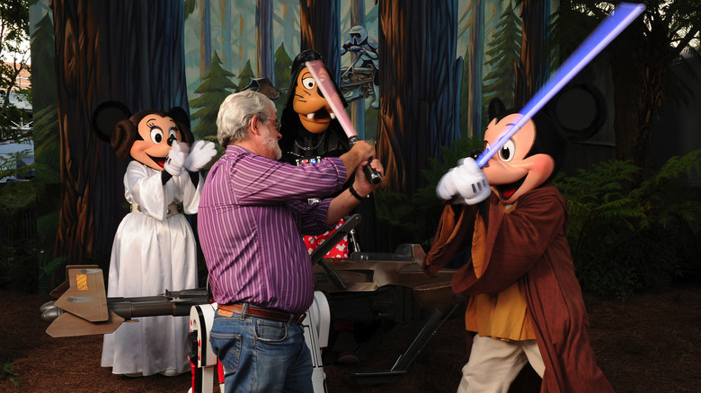 George Lucas dueling lightsabers with Mickey Mouse