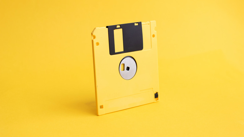 Yellow floppy disk on yellow background