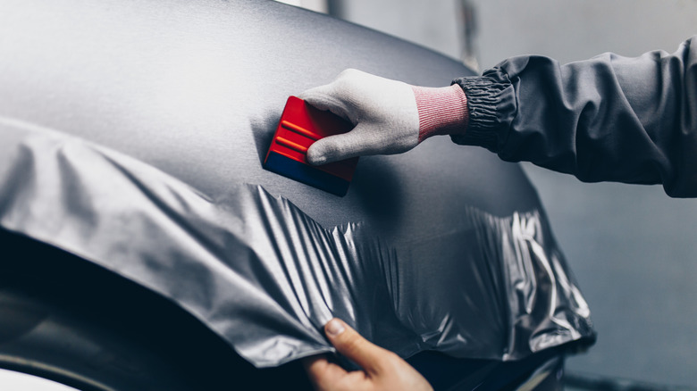 person installing car wrap