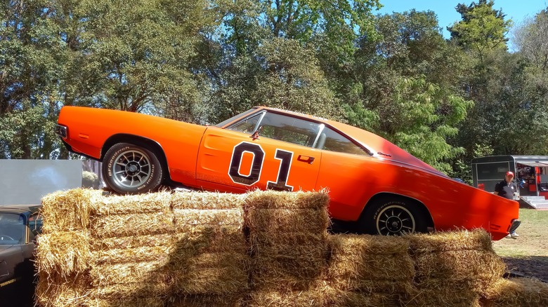 The General Lee on bales of hay in front of trees