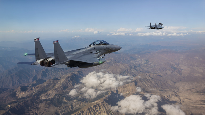Fighter jets flying over mountains 
