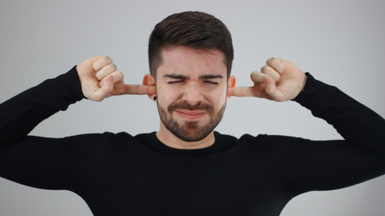 Person shielding from noise. 