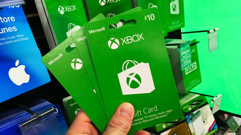 Someone holding Xbox Live gift cards