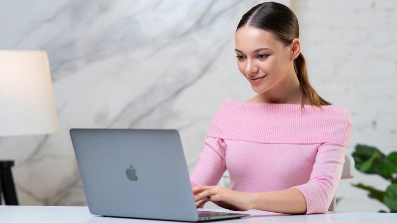 woman working on a MacBook