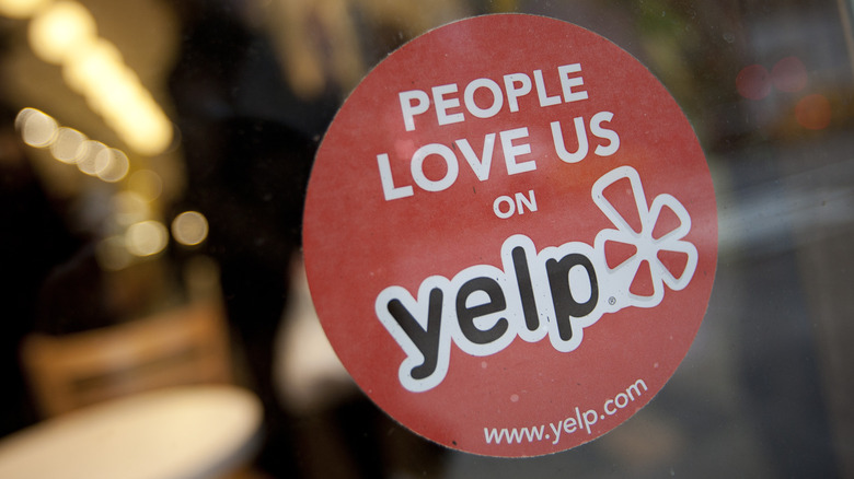 photo of a circular Yelp sticker on the window for a business