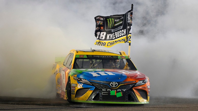 Kyle Busch sporting victory flag after win