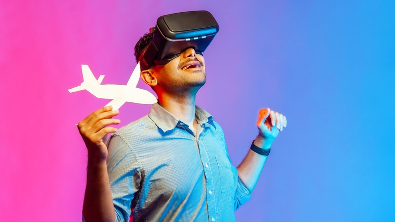 man with VR headset and airplane