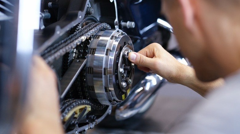 Person fixing motorcycle