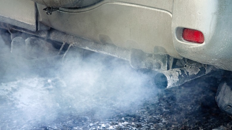 Car expelling blue exhaust smoke