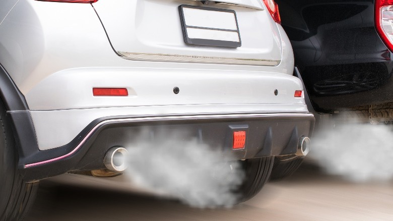 Dual exhaust hatchback emitting exhaust fumes