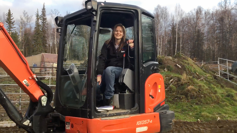 Lisa Kelly sitting in orange excavator