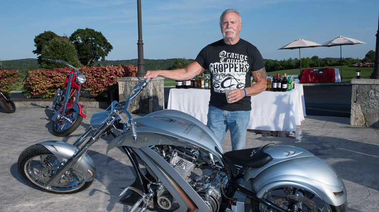 Paul Teutul Sr. standing with motorcycle