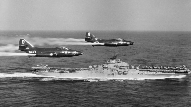 two F9F Panther flying above an aircraft carrier